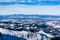 Lowland panorama seen from the peak in the Tatra Mountains in winter. In the valley, residential buildings of the city of Zakopane Royalty Free Stock Photo