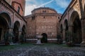 Lowlight Pilate\'s cloister with arcades with 8th century font in the yard, Bologna ITALY Royalty Free Stock Photo