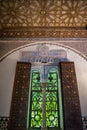 Lowlight window with arches and column with wall and ceiling with Islamic decoration, Seville SPAIN Royalty Free Stock Photo