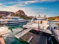 Loxuary yachts ant motor boards on Poltu Quatu port. Sunny morning scene of Sardinia island, Italy, Europe.