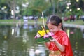 Loy Krathong festival, Asian Child girl in Thai traditional dress with holding krathong for forgiveness Goddess Ganges to celebrat Royalty Free Stock Photo