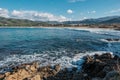 Lozari beach and snow capped mountains in Corsica