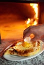 Lozhit cook egg yolk in Ajarian khachapuri. Preparation. Royalty Free Stock Photo