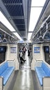 LRT Jakarta train interior seating area, departure station, bright train interior, empty seats. Passenger seatless train with blue Royalty Free Stock Photo