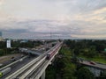 LRT , Monorail movement on track moving fast taken at station Cibubur. with background of traffic ,mountain and sky. Jakarta,