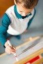 Lttle boy drawing on white board with felt pen and smiling Royalty Free Stock Photo