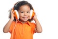 Lttle girl with an afro hairstyle enjoying her music on bright orange headphones Royalty Free Stock Photo