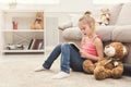 Lttle girl and her teddy bear reading book Royalty Free Stock Photo