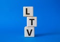 LTV - Life Time Value symbol. Concept word LTV on wooden cubes. Beautiful blue background. Business and LTV concept. Copy space Royalty Free Stock Photo