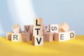 LTV written on wooden cubes, yellow background Royalty Free Stock Photo