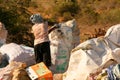 Woman picking through trash piled up at a local dump site