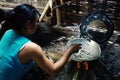 Keo the wife of a fisherman cooking some small fry fish for lunch