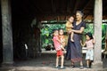 lao family with mother and cute kids waiting under their stilt house