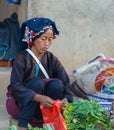 Luang Namtha, Laos - circa november, 2019: portrait adult Akha woman at market wearing traditional clothings belonging to minority
