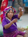 Luang Namtha, Laos - circa november, 2019: portrait adult Akha woman at market wearing traditional clothings belonging to minority