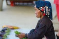 Luang Namtha, Laos - circa november, 2019: portrait adult Akha woman at market wearing traditional clothings belonging to minority