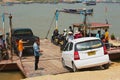 People embark car to a local ferry boat at Mekong river bank in Luang Prabang, Laos.