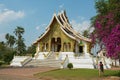 Tourist takes photo of the Haw Pha Bang Buddhist temple at the Royal Palace Museum in Luang Prabang, Laos. Royalty Free Stock Photo