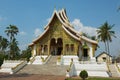 Tourists visit Buddhist Temple at Haw Kham Royal Palace complex in Luang Prabang, Laos. Royalty Free Stock Photo