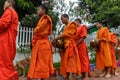 Buddhist monks collect alms in Luang Prabang, Laos