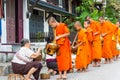 Buddhist monks collecting alms in the morning in Luang Prabang, Laos.