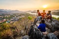 Luang Prabang, Laos - MARCH 6 2020: Lao kids on the top of the Phousi Hill watching over the city as sunset Royalty Free Stock Photo