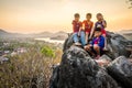 Luang Prabang, Laos - MARCH 6 2020: Lao kids on the top of the Phousi Hill watching over the city as sunset Royalty Free Stock Photo