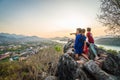 Luang Prabang, Laos - MARCH 6 2020: Lao kids on the top of the Phousi Hill watching over the city as sunset Royalty Free Stock Photo