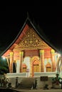Luang Prabang, Laos - 2019-11-18: Wat Aham buddhist temple at night. Exterior view of the main entrance and facade.