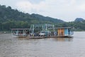 luangprabang lao-july18,2023 : land vehicle and people on car ferry crossing mekong river at xiangman port luangprabang district