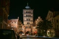 Lubeck Burgtor gate tower at night and a light trace of a bicycle driving through, historic brick building of the former city wall Royalty Free Stock Photo