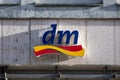 Lubeck, Germany, January 15, 2022: dm logo in sunny side light on a building facade, brand mark of the drogerie markt, a chain of Royalty Free Stock Photo