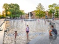 Children playing in beautiful modern fountain in park, Lublin