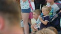 Little Girl Drinks Water During Street Performance