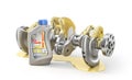 Lubricant concept. Crankshaft in the oil with oil bottle on a white background