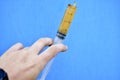 Lubricants in a syringe in your hand on a blue background Royalty Free Stock Photo