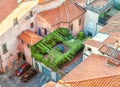 Lucca, Italy - August 18, 2013: Secluded roof garden of an old Italian building. Urban rooftop from medieval Italy