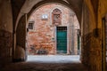 Lucca, Italy - 6/8/2022: Bicycle at rest in traditional Tuscan courtyard in Lucca