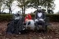 A family sitting on a bench disguised as characters from the movie Nightmare Before Christmas at the Lucca Comics & Games