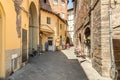 Old narrow medieval street with bar and shops in the historic center of old town Lucca, Tuscany, Italy Royalty Free Stock Photo