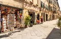 Old narrow medieval street with bar and shops in the historic center of old town Lucca, Tuscany Royalty Free Stock Photo