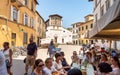 San Frediano square with people enjoying the outdoor bar and views of the Basilica of San Frediano in old town Lucca, Tuscany, Royalty Free Stock Photo