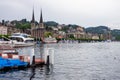 Lucerne lake side view marina bay with ships old town in the background overcast day