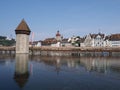 Historical buildings, chapel bridge and tower at Reuss river in european Lucerne city at Switzerland