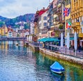 Pedestrian Rathausquai promenade of Reuss river with outdoor restaurants, on March 30 in Lucerne, Switzerland