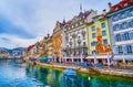 Rathausquai embankment and scenic medieval buildings with colorful frescoes, on March 30 in Lucerne, Switzerland