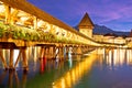 Lucerne wooden Chapel Bridge and tower colorful evening view