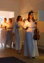 Lucia parade with singing girls and boys in white dresses holding candles. Traditional celebration of the suffering of saint Lucia