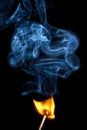 Lucifer/match burning with smoke Royalty Free Stock Photo
