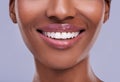 Lucious lips. a young womans mouth against a purple background.